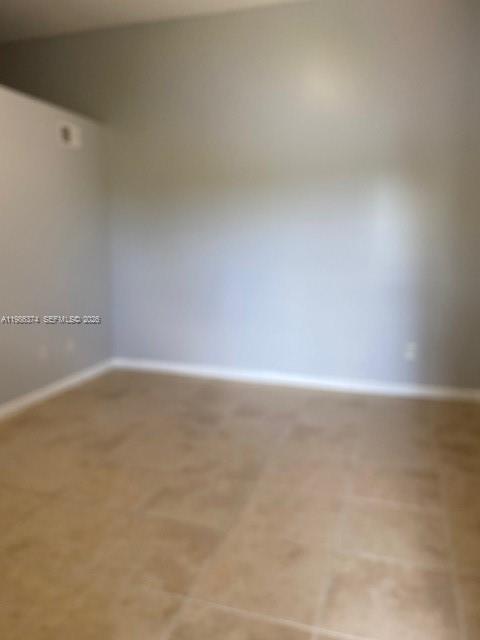 An empty room with light gray walls and beige tile flooring — 1385 Crystal Way # L, Delray Beach FL 33444, DELRAY BEACH, FL