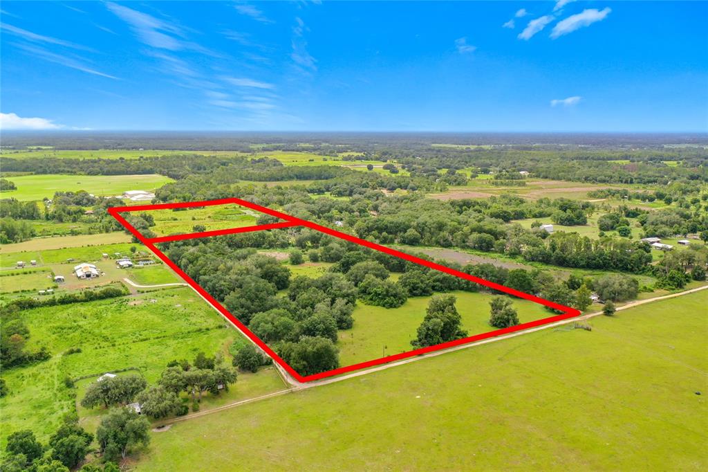 An aerial view shows a rural property outlined in red, featuring wooded areas and pasture — 2736 EMPIRE CHURCH ROAD, GROVELAND, FL