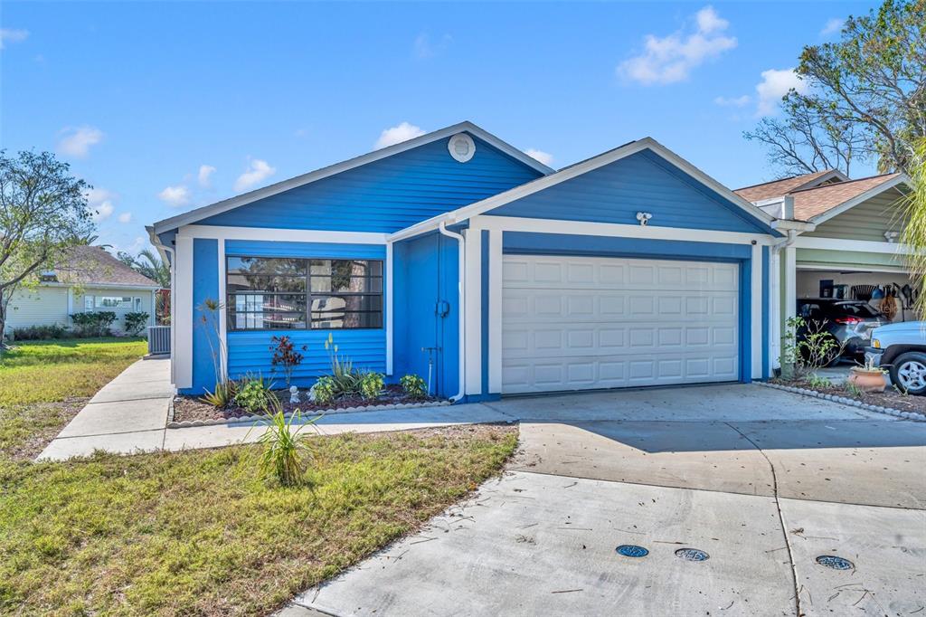 An aerial view shows waterfront houses with docks and a boat on a canal — 4522 MARINE PARKWAY, NEW PORT RICHEY, FL