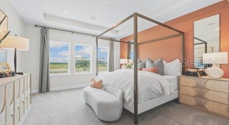 A bedroom features a canopy bed, a terracotta accent wall, and large windows with views — 3116 LUMBER FALLS DRIVE, PLANT CITY, FL