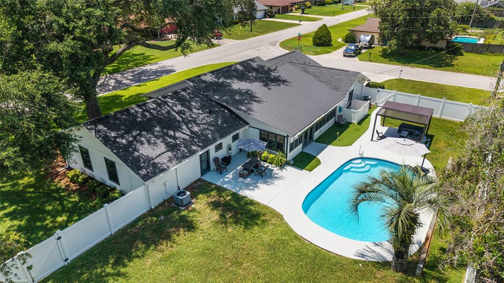 An aerial view of a single-story house with a swimming pool and a fenced backyard — 3453 SE 25TH AVENUE, OCALA, FL