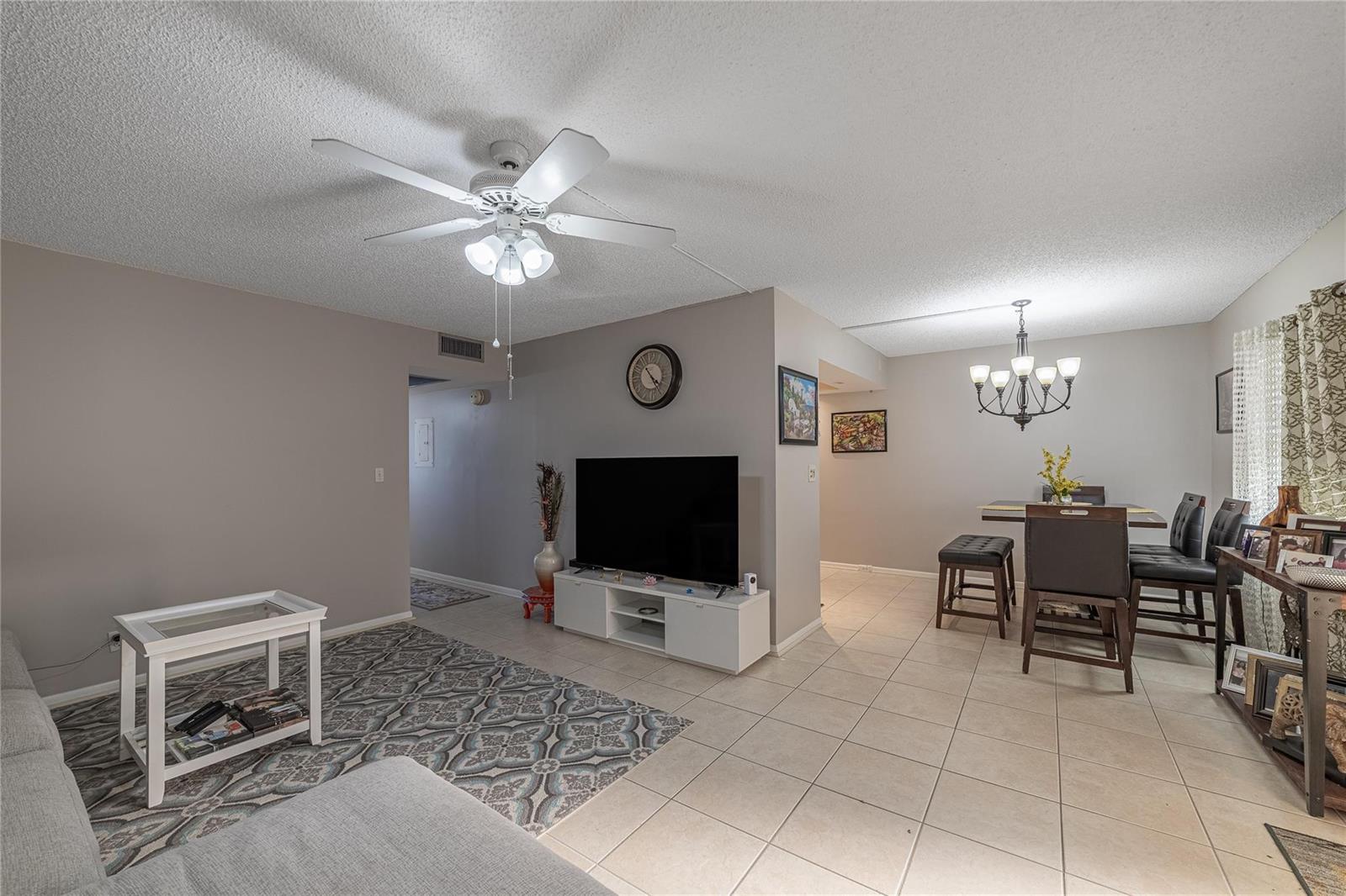 A living room and dining area with tile floors, a ceiling fan, and neutral walls — 1902 Bermuda Circle, Coconut Creek FL 33066, COCONUT CREEK, FL