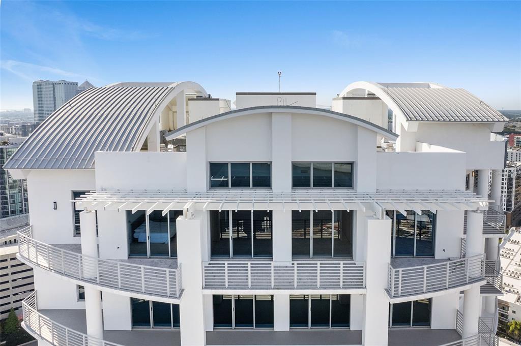 An exterior view of a white high-rise building with curved roofs and multiple balconies — 1209 E CUMBERLAND AVENUE UNIT 2902, TAMPA, FL