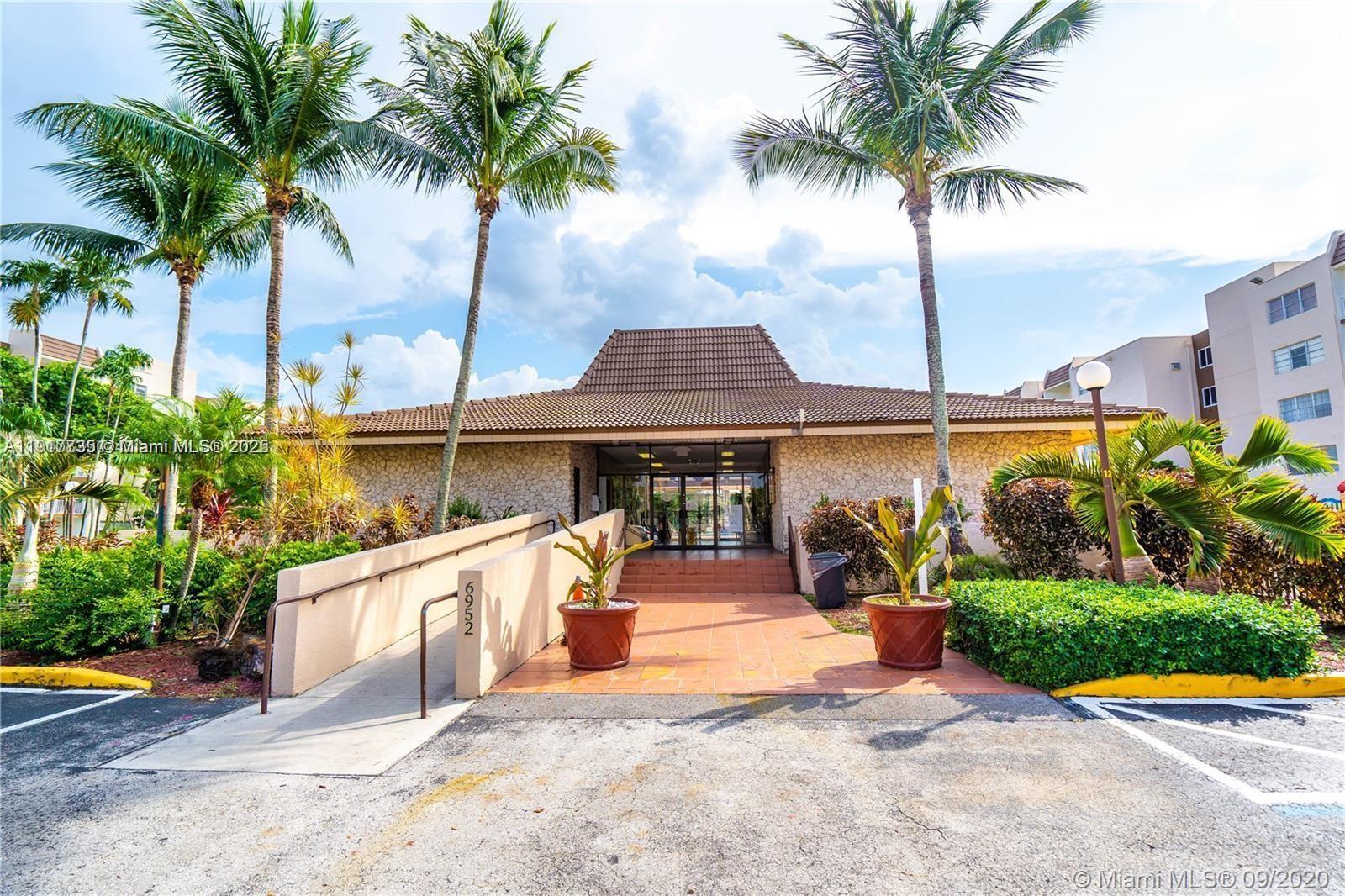 The exterior of a building features a stone facade, a tiled roof, and a wheelchair ramp — 6930 Miami Gardens Dr # 410, Hialeah FL 33015, HIALEAH, FL