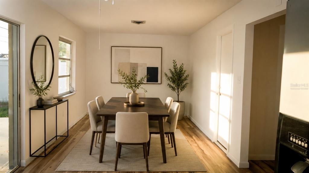A dining room features a dark wood table, six upholstered chairs, and a minimalist console table — 1051 VENETIAN PARKWAY, VENICE, FL