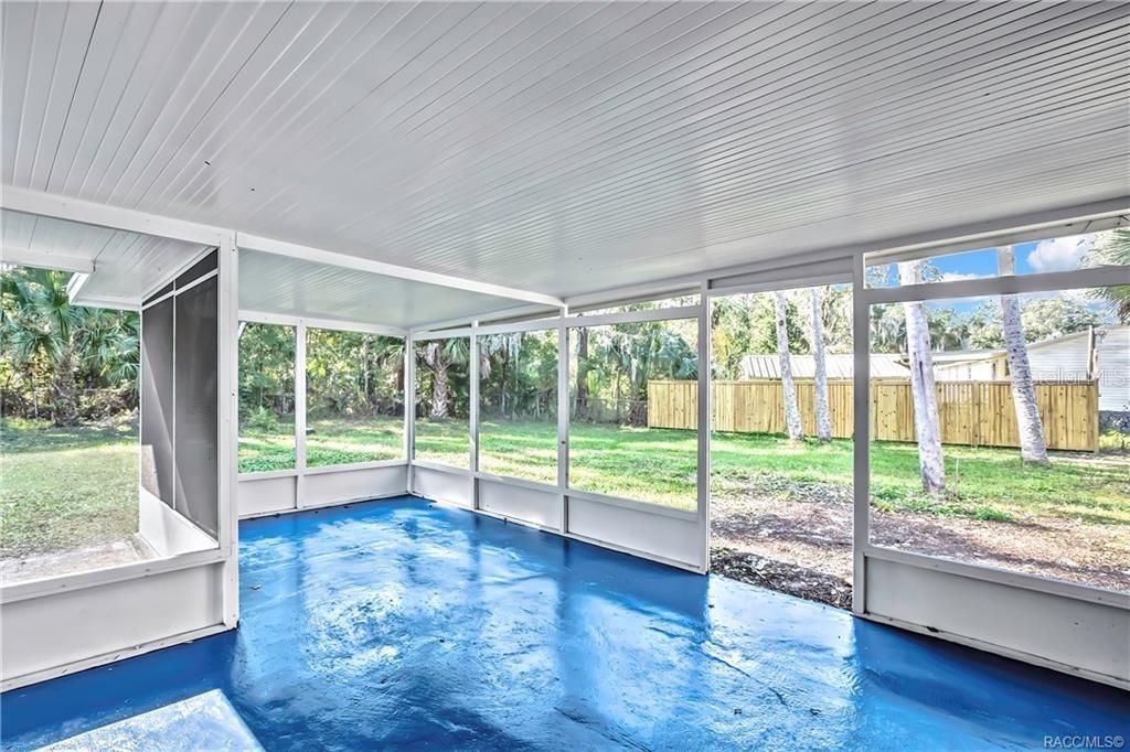 A screened-in porch with a blue painted concrete floor and a white paneled ceiling — 8340 W AMELIA COURT, HOMOSASSA, FL