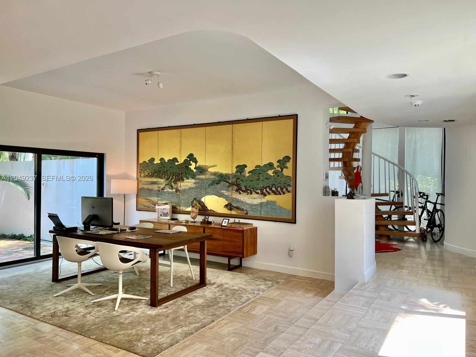 A home office features a wooden desk, a large gold-leaf wall screen, and a spiral staircase — 4101 Battersea Rd # 1, Miami FL 33133, MIAMI, FL
