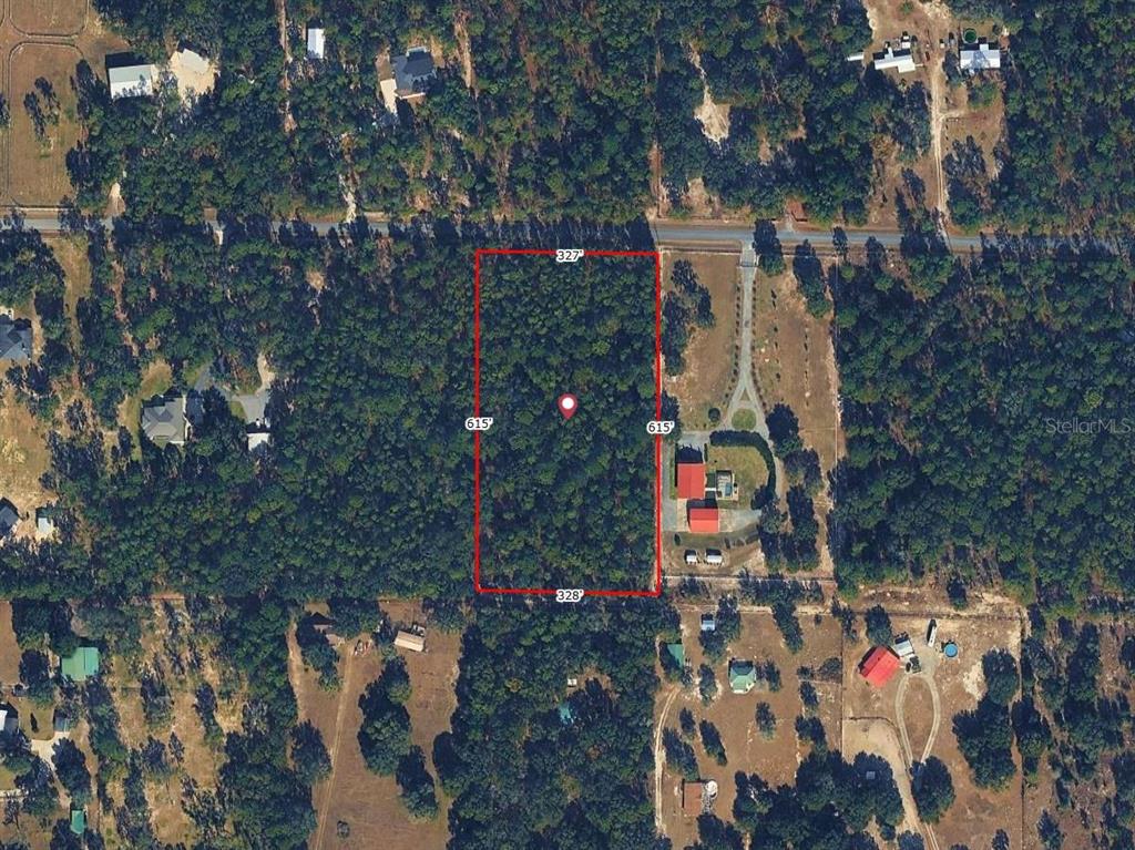 An aerial view shows a rectangular, wooded plot of land outlined in red with dimensions — SW 97TH PL, DUNNELLON, FL
