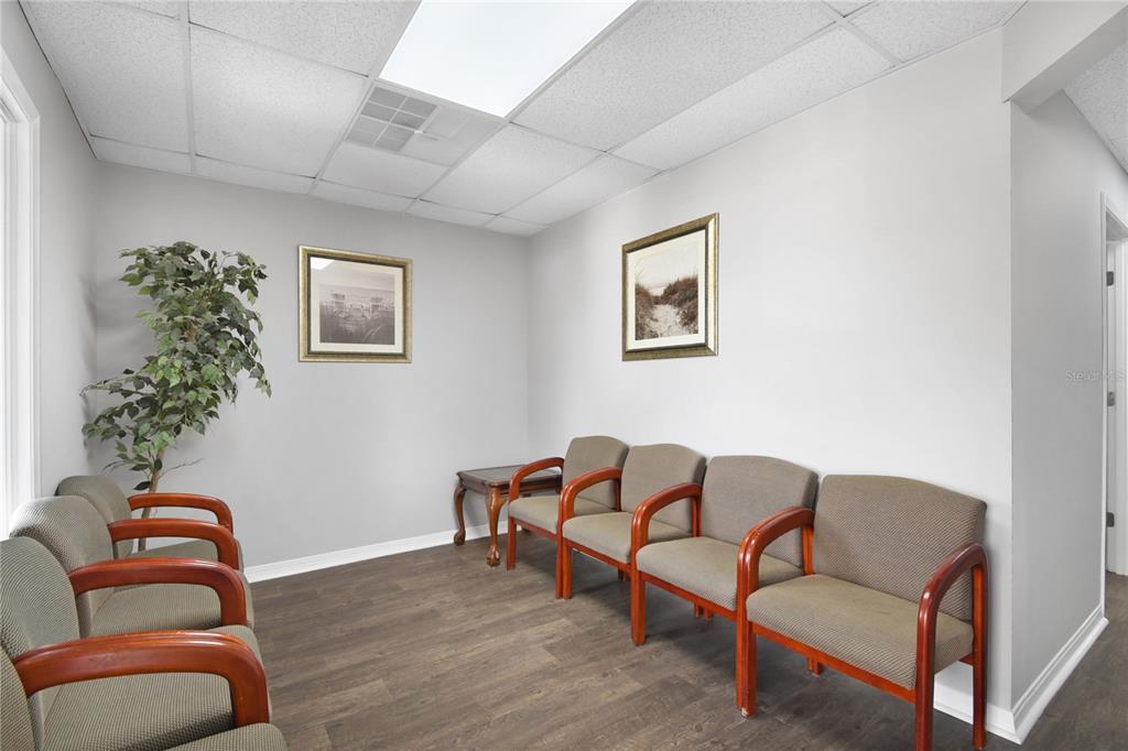 A waiting room with gray walls, wood-look flooring, and several chairs with wooden armrests — 1840 DUNN AVENUE UNIT 5, JACKSONVILLE, FL