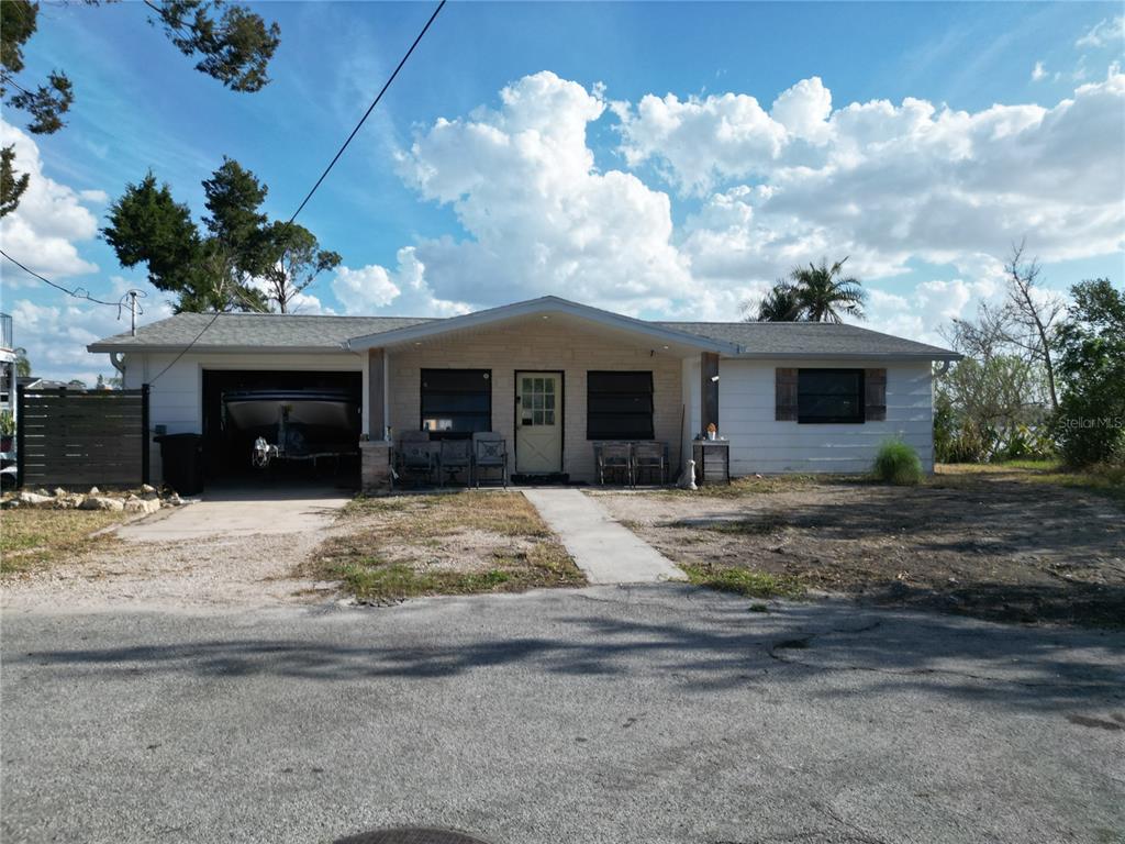 A single-story house with a garage, a front porch, and a light-colored exterior — 8402 DAMEN LANE, PORT RICHEY, FL