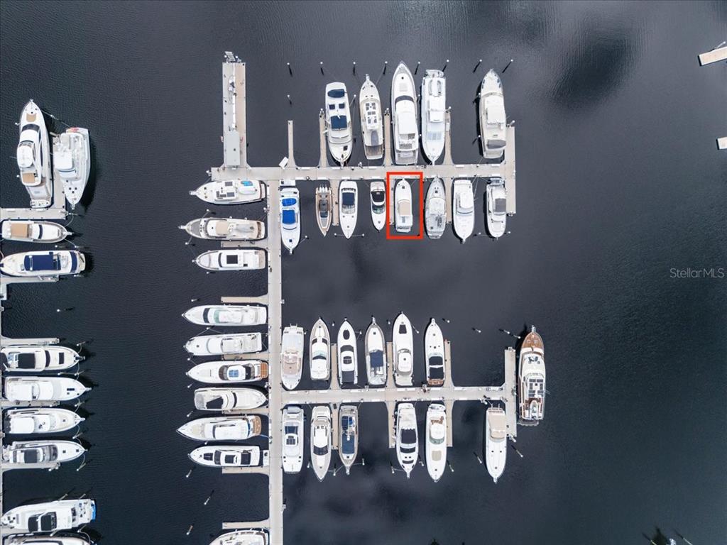 An aerial view shows numerous boats docked in slips at a marina — 102 RIVIERA DUNES WAY UNIT S-39, PALMETTO, FL