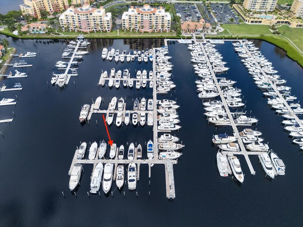 An aerial view shows a marina filled with numerous boats docked at multiple piers — 102 RIVIERA DUNES WAY UNIT S-39, PALMETTO, FL