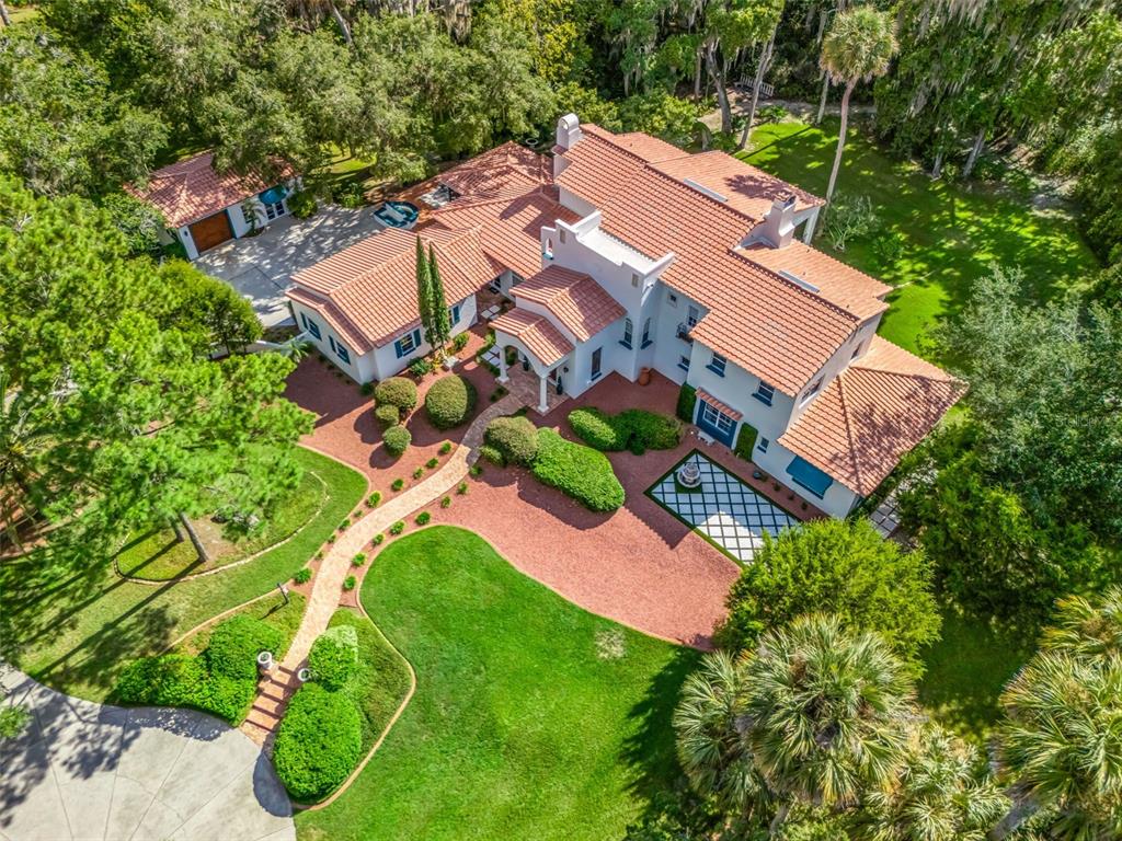 An aerial view shows a large white house with a red tile roof and landscaping — 4200 SW 7TH AVE ROAD, OCALA, FL