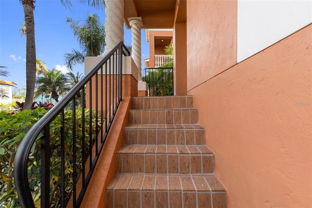 An outdoor staircase with brown tiled steps leads up to a covered building entrance — 905 VILLA VENICIA WAY, TAMPA, FL