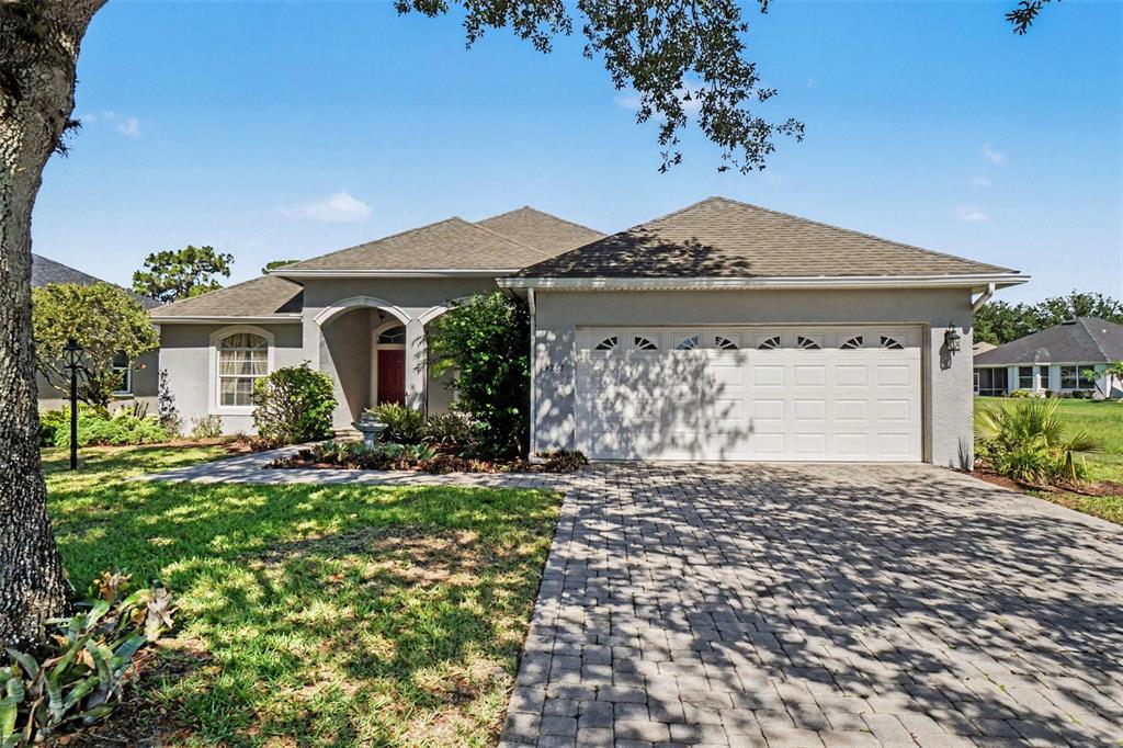 A single-story house with a paved driveway, a two-car garage, and a landscaped front yard — 4287 N COURSE LANE, AVON PARK, FL