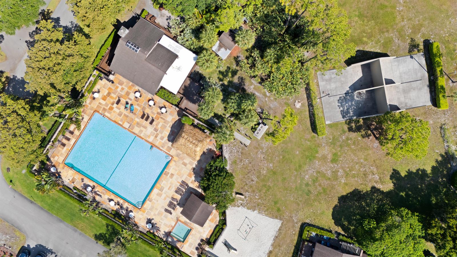 Aerial view of a swimming pool, patio, and sports court on a landscaped property — 22656 Vistawood Way # 29d, Boca Raton FL 33428, BOCA RATON, FL