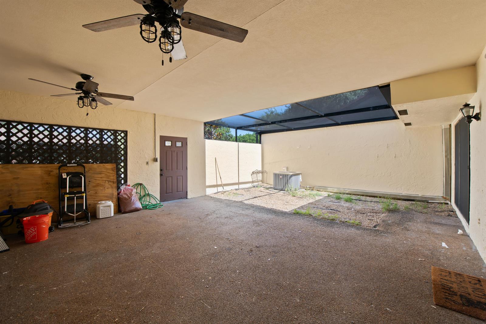 A covered patio features a concrete floor, two ceiling fans, and an open-air screened section — 22656 Vistawood Way # 29d, Boca Raton FL 33428, BOCA RATON, FL