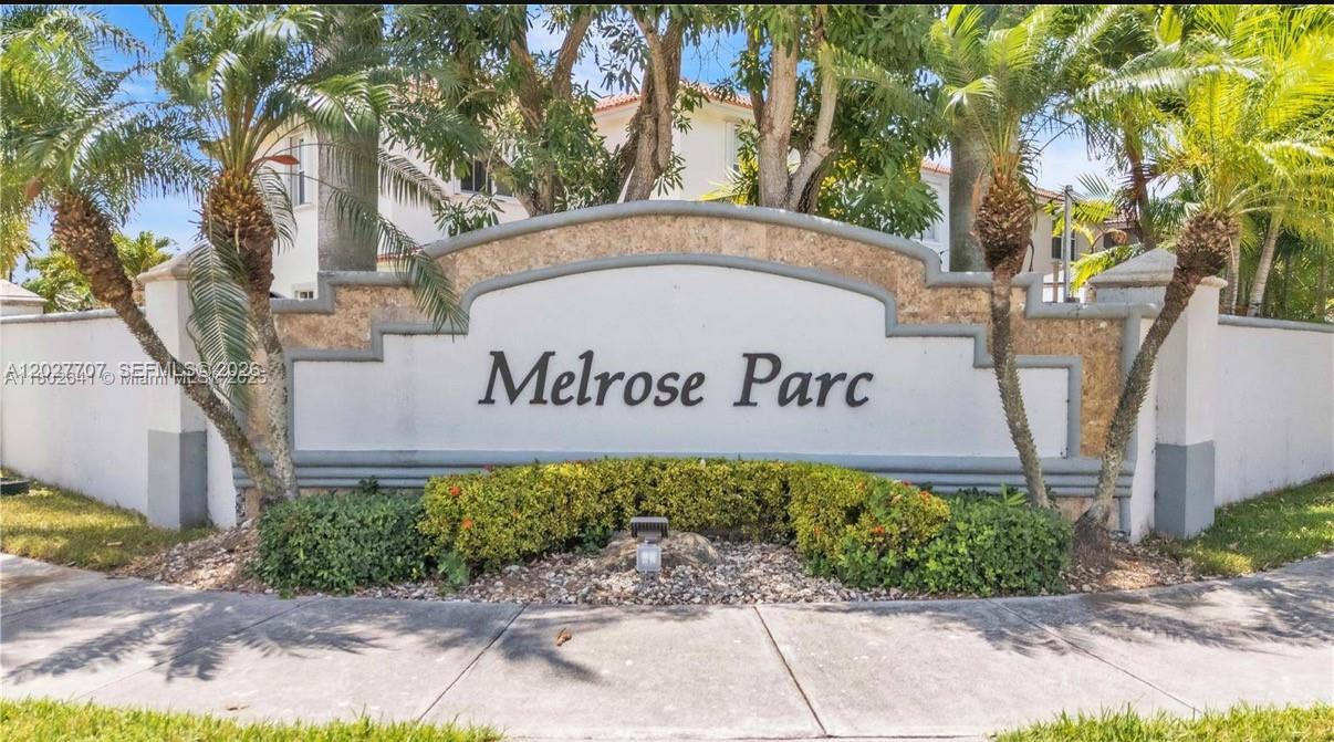 A stone entrance sign for Melrose Parc is surrounded by palm trees and landscaping — 16628 SW 47th Ter, Miami FL 33185, MIAMI, FL