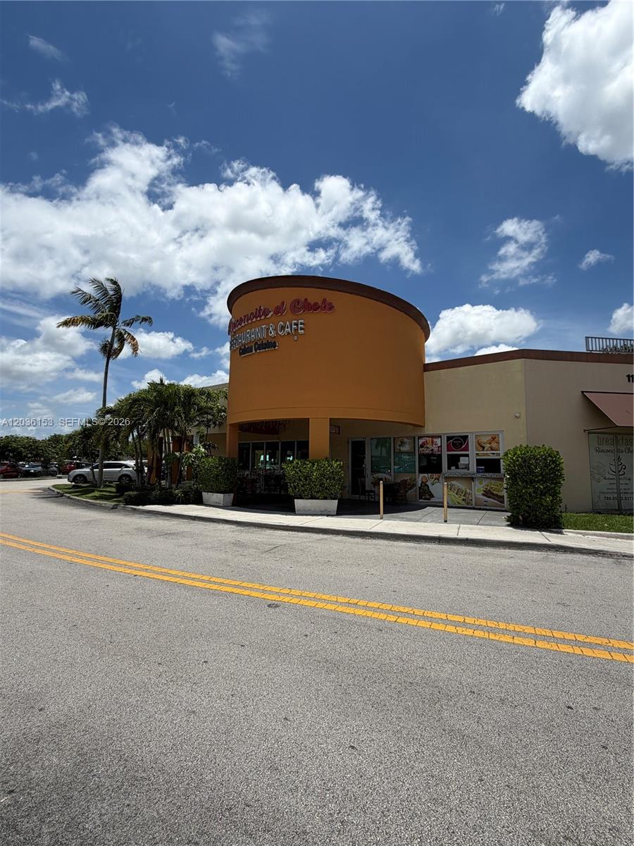 A low-angle exterior view of a Cuban restaurant and cafe with a curved orange facade — 11735 SW 147th Ave #38, Miami FL 33196, MIAMI, FL