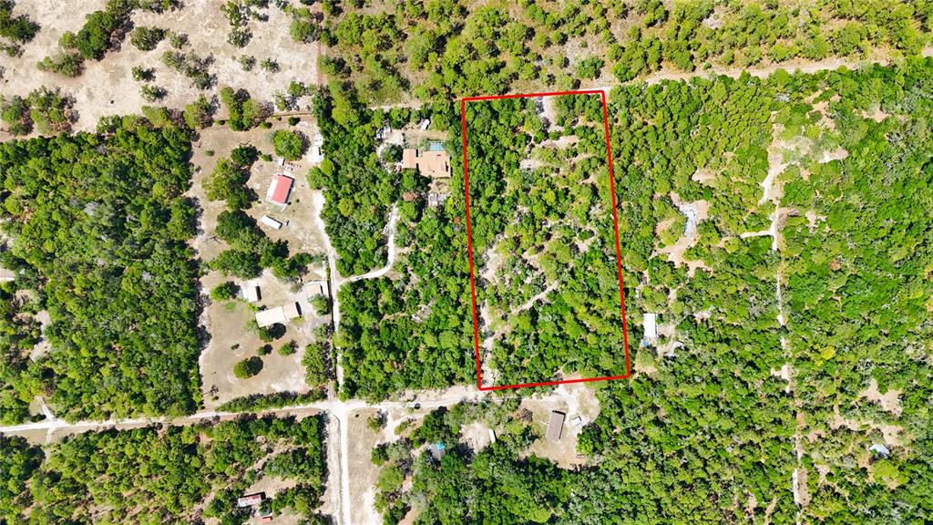 An aerial view shows a rectangular plot of land outlined in red amidst wooded terrain — 0 WINDHAVEN LANE, BROOKSVILLE, FL