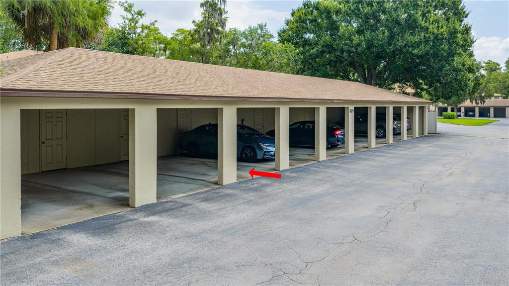 A row of covered parking spaces with concrete pillars and a shingled roof — 1601 BIG TREE ROAD UNIT 803, DAYTONA BEACH, FL