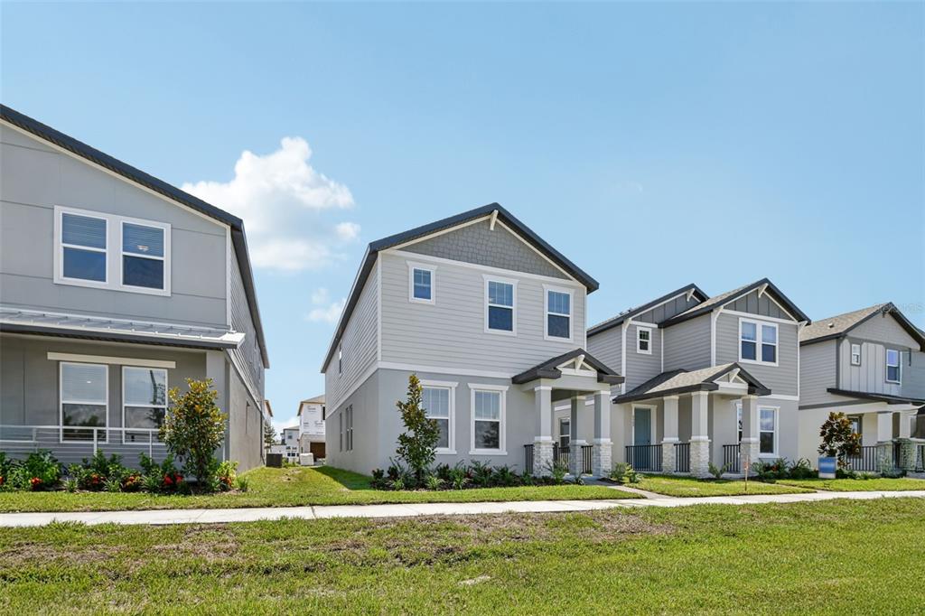 A row of modern two-story suburban houses with light gray siding and front porches — 4505 CROSS PRAIRIE PARKWAY, ST CLOUD, FL