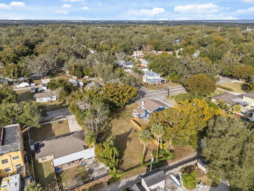 An aerial view shows a vacant lot situated between several houses and tree-lined streets — TBD SANFORD AVENUE, SANFORD, FL