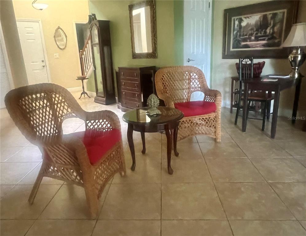 A paved walkway leads to the front entrance of a house with a small patio — 618 MAPLE OAK CIRCLE UNIT 112, ALTAMONTE SPRINGS, FL
