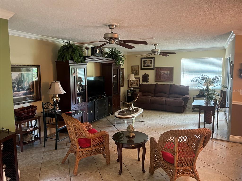 A concrete walkway leads between two building walls toward a metal gate and yard — 618 MAPLE OAK CIRCLE UNIT 112, ALTAMONTE SPRINGS, FL