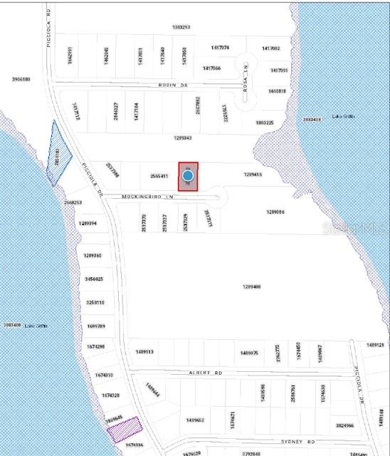 This is a property map showing a highlighted lot located near a lake — MOCKINGBIRD LANE, FRUITLAND PARK, FL