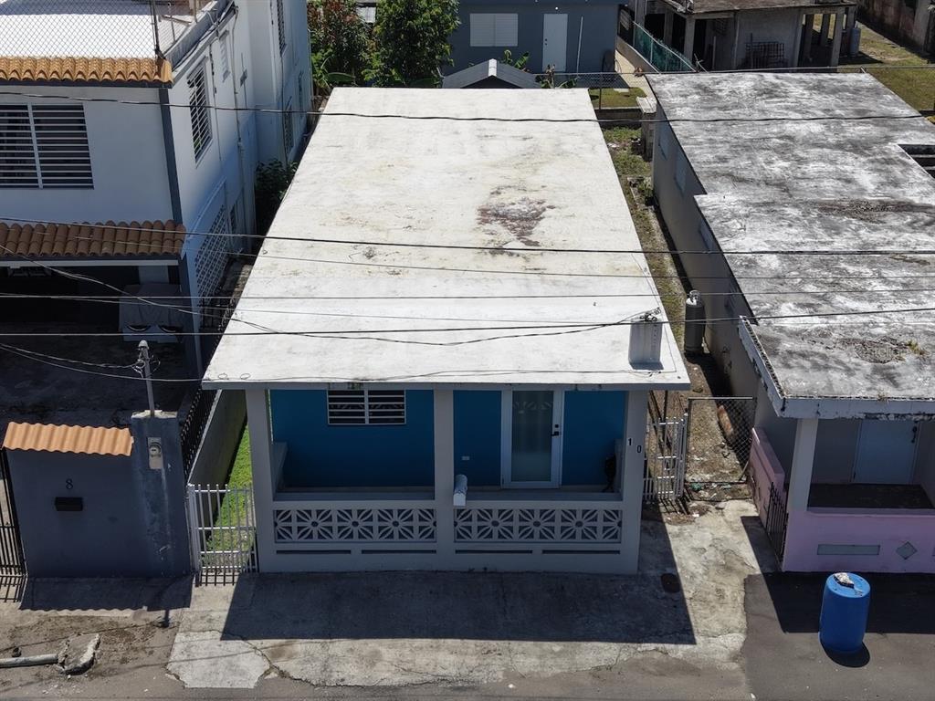 An aerial view shows a blue house with a flat white roof and front porch — 10 (70) DOCTOR. VIDAL ST. (PR-3), PUNTA SANTIAGO, PR