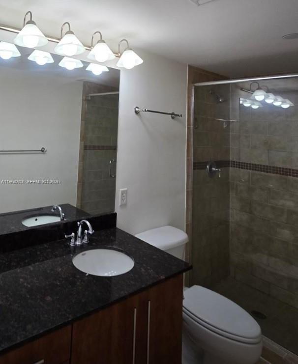 A bathroom features a dark granite vanity, a glass-enclosed shower, and a white toilet — 7350 SW 89th St # 1804S, Miami FL 33156, MIAMI, FL