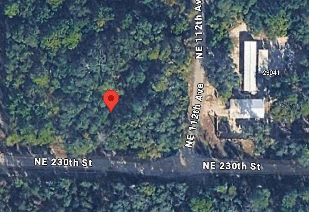 This is a satellite map view showing a wooded lot near a road intersection — NO SITUS, FORT MC COY, FL