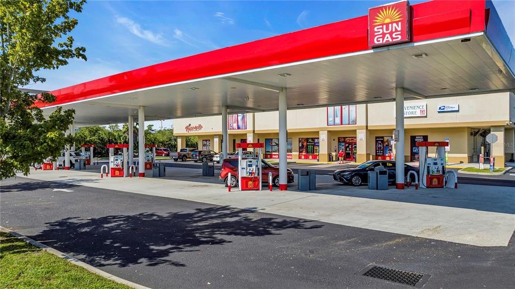 A Sun Gas gas station with a red canopy and a convenience store building — 5600 BUTLER NATIONAL DRIVE, ORLANDO, FL