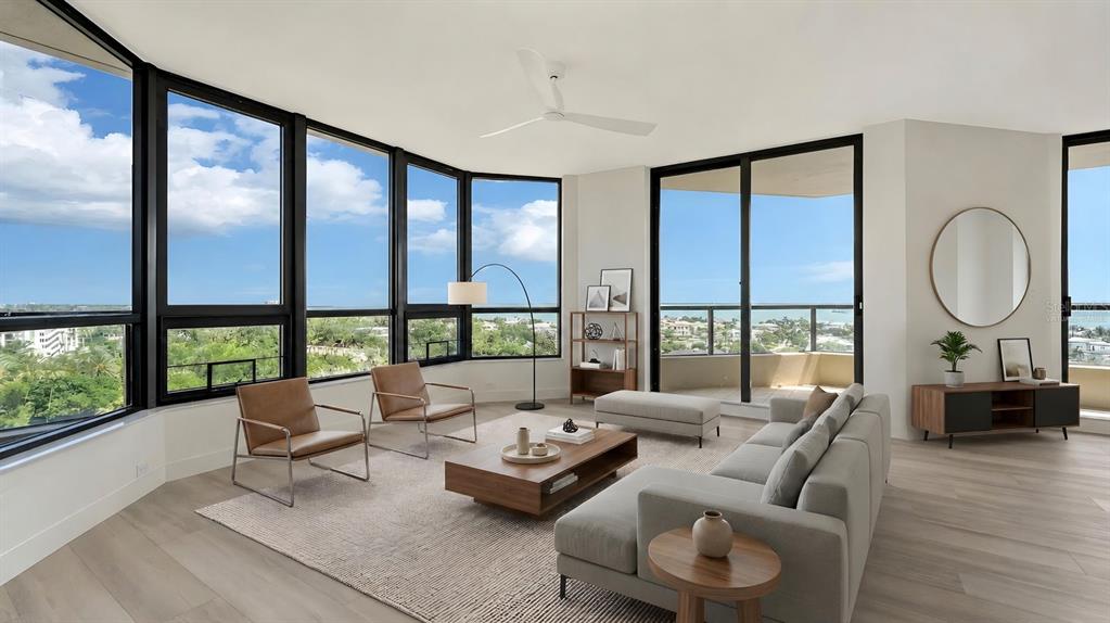A modern living room features floor-to-ceiling windows, light wood flooring, and a neutral sofa — 1211 GULF OF MEXICO DRIVE UNIT 701, LONGBOAT KEY, FL