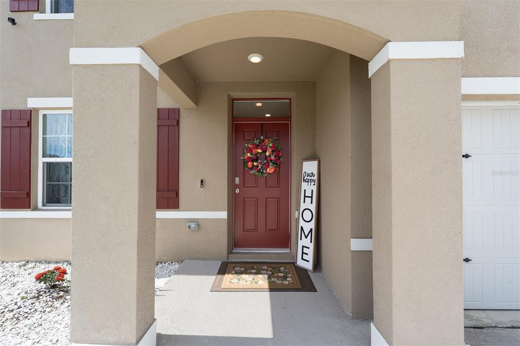 The exterior view shows a beige house entrance with a red door and white shutters — 4641 BERNARD BOULEVARD, HAINES CITY, FL