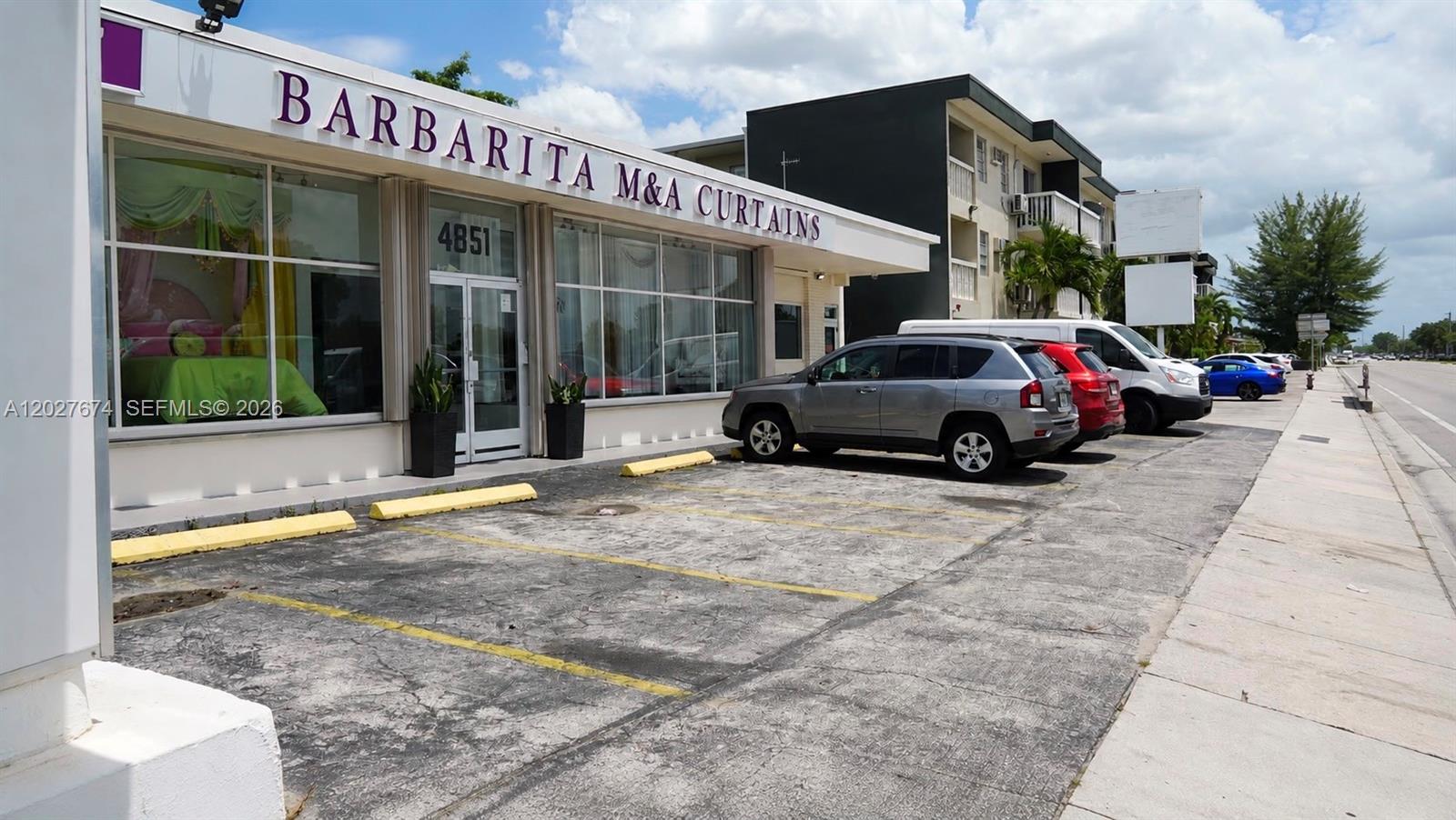 A commercial building with a parking lot in front and a multi-story apartment complex nearby — 4851 E 8th Ave, Hialeah FL 33013, HIALEAH, FL