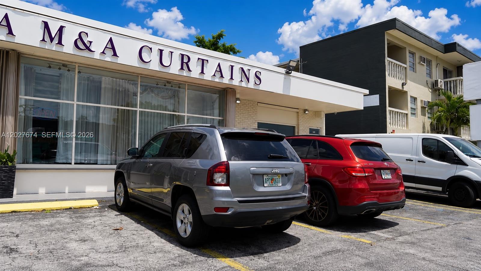 A gray Jeep and a red SUV are parked in front of a curtain store — 4851 E 8th Ave, Hialeah FL 33013, HIALEAH, FL