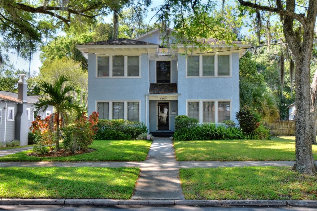 A two-story light blue house with a central entrance and a front lawn — 211 E PARK STREET, LAKELAND, FL