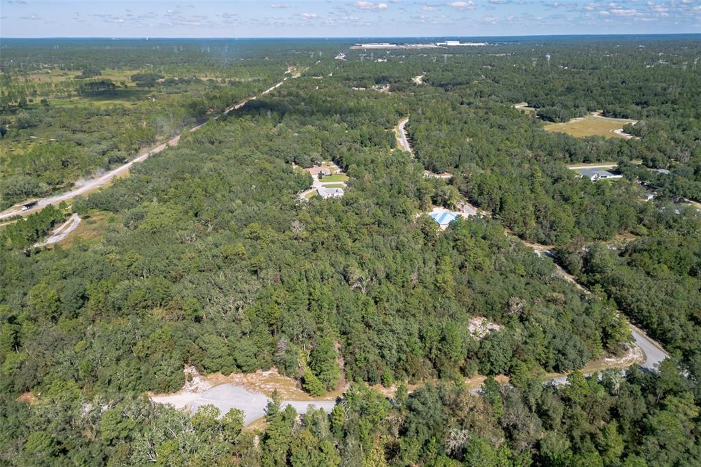 An aerial view shows a wooded residential area with scattered houses and paved roads — 0000 SW 174 STREET, OCALA, FL