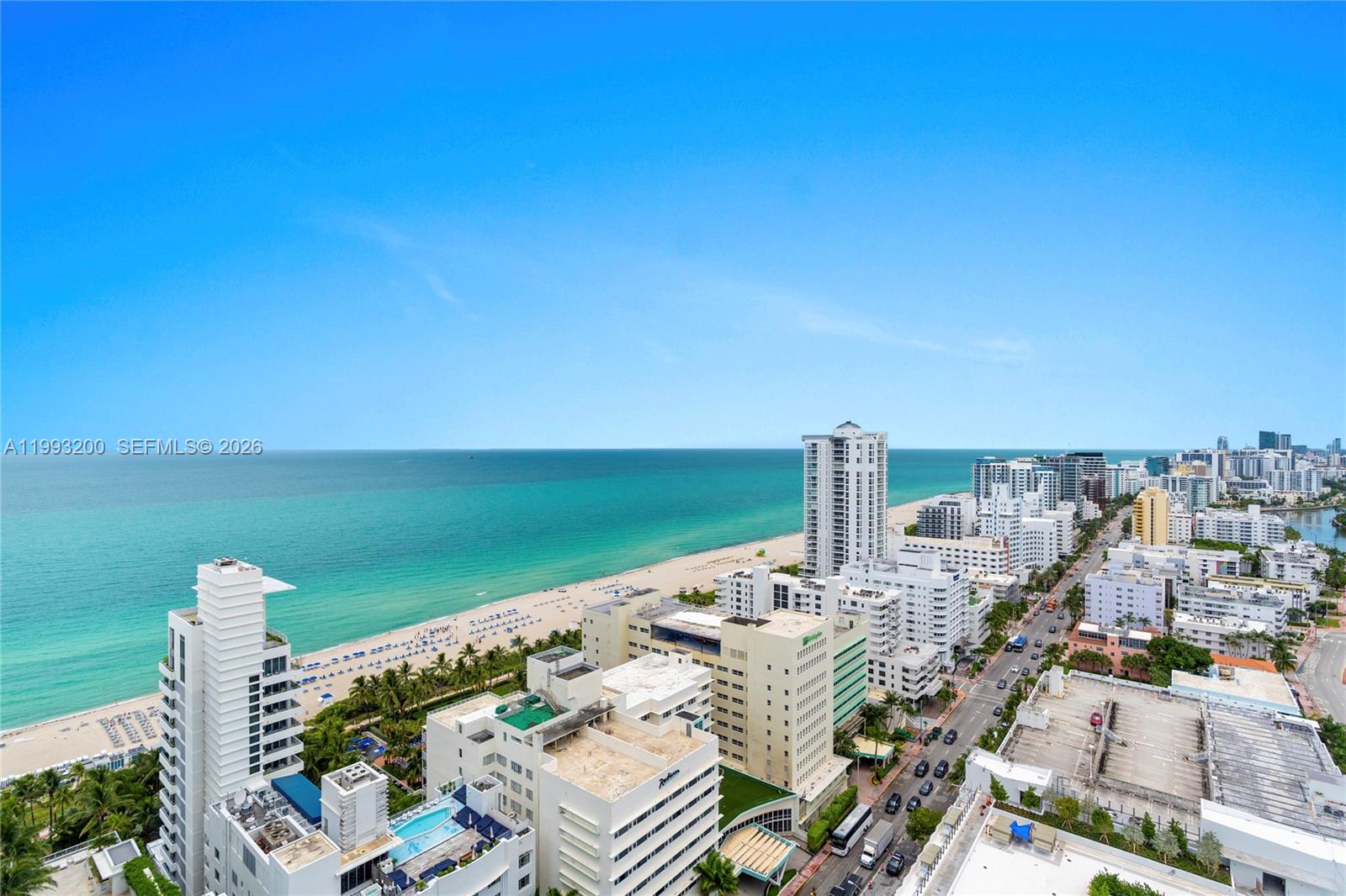 An aerial view shows a coastal city with high-rise buildings, a beach, and the ocean — 4401 Collins Ave # 2612, Miami Beach FL 33140, MIAMI BEACH, FL