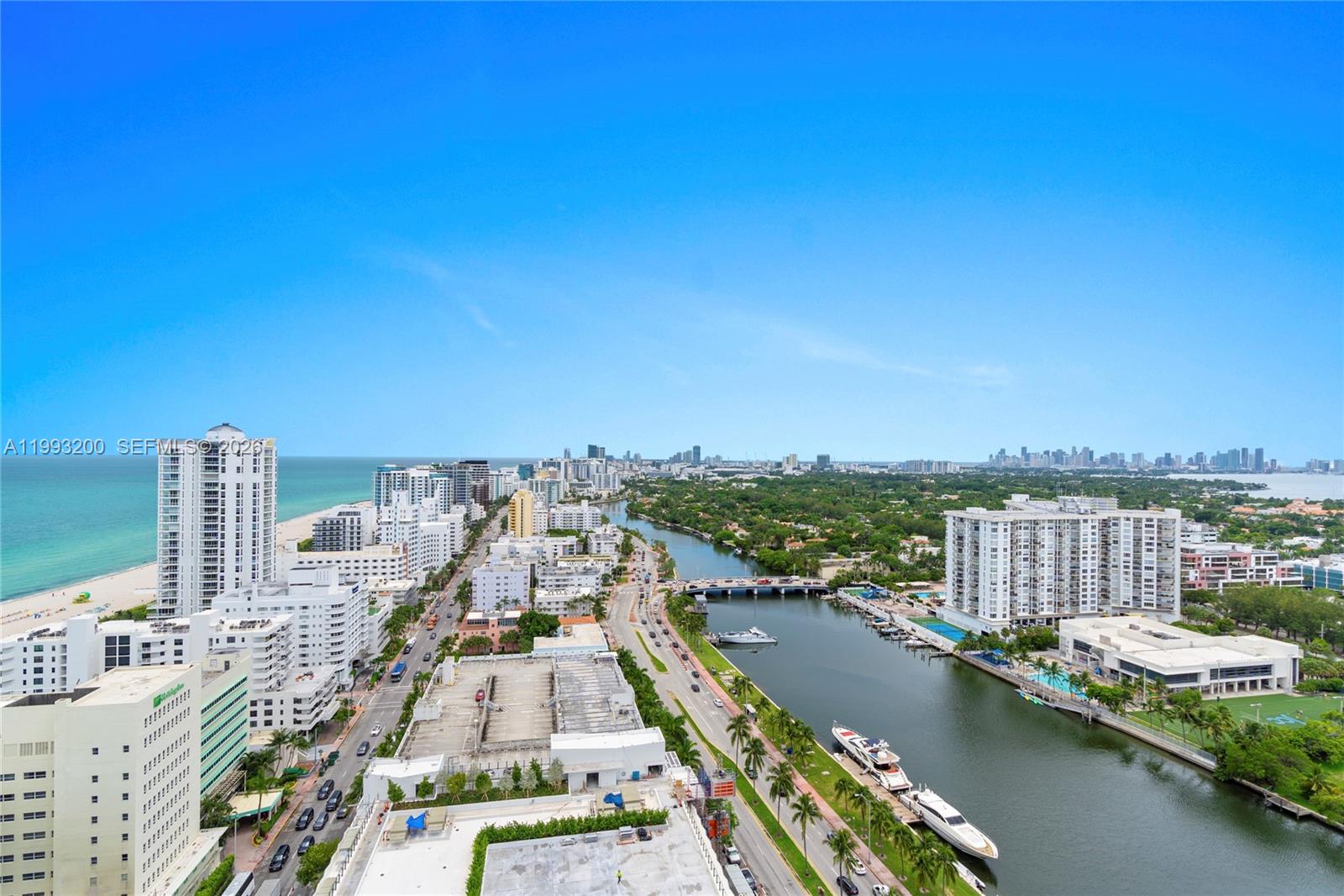 An aerial view shows a coastal city with a canal, high-rise buildings, and beach — 4401 Collins Ave # 2612, Miami Beach FL 33140, MIAMI BEACH, FL