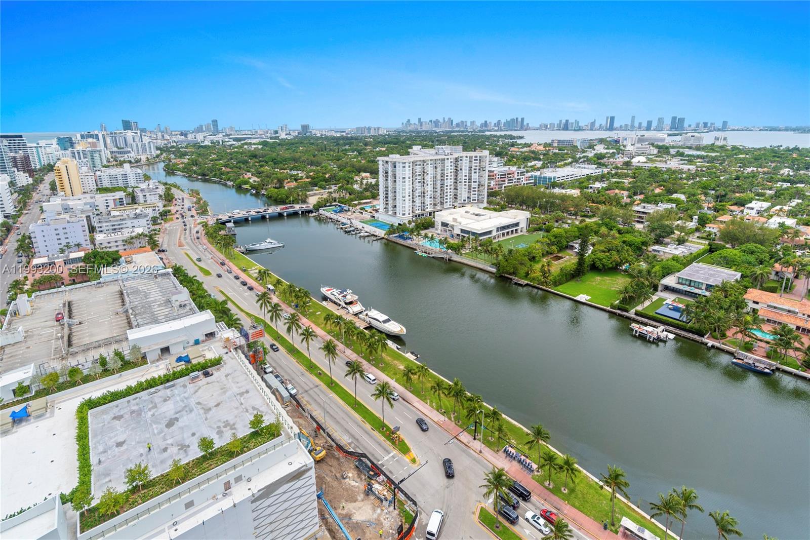 An aerial view shows a waterway lined with palm trees, boats, and urban buildings — 4401 Collins Ave # 2612, Miami Beach FL 33140, MIAMI BEACH, FL