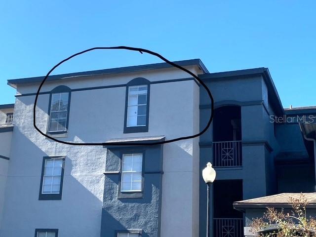 Exterior view of a multi-story apartment building with two highlighted windows on the top floor — 8414 LUCUYA WAY UNIT 308, TEMPLE TERRACE, FL