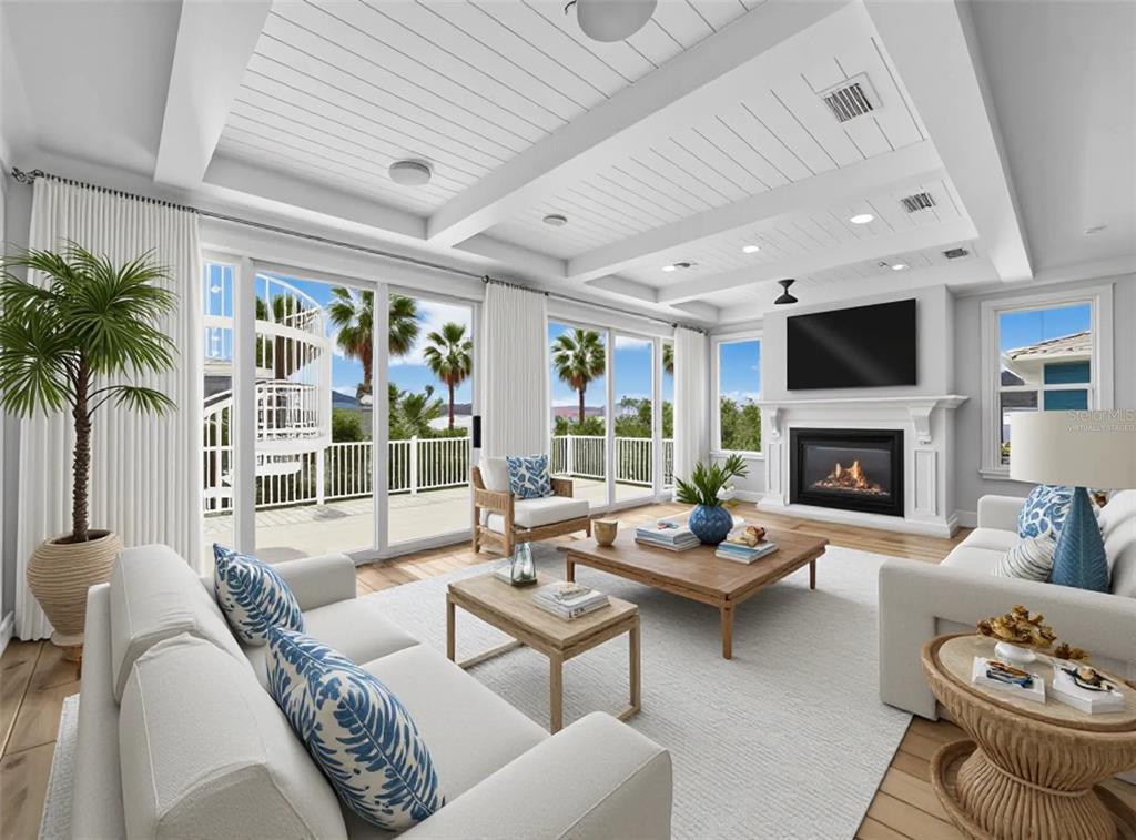 A bright living room features a coffered ceiling, fireplace, and sliding glass doors to a deck — 333 FIREHOUSE COURT, LONGBOAT KEY, FL