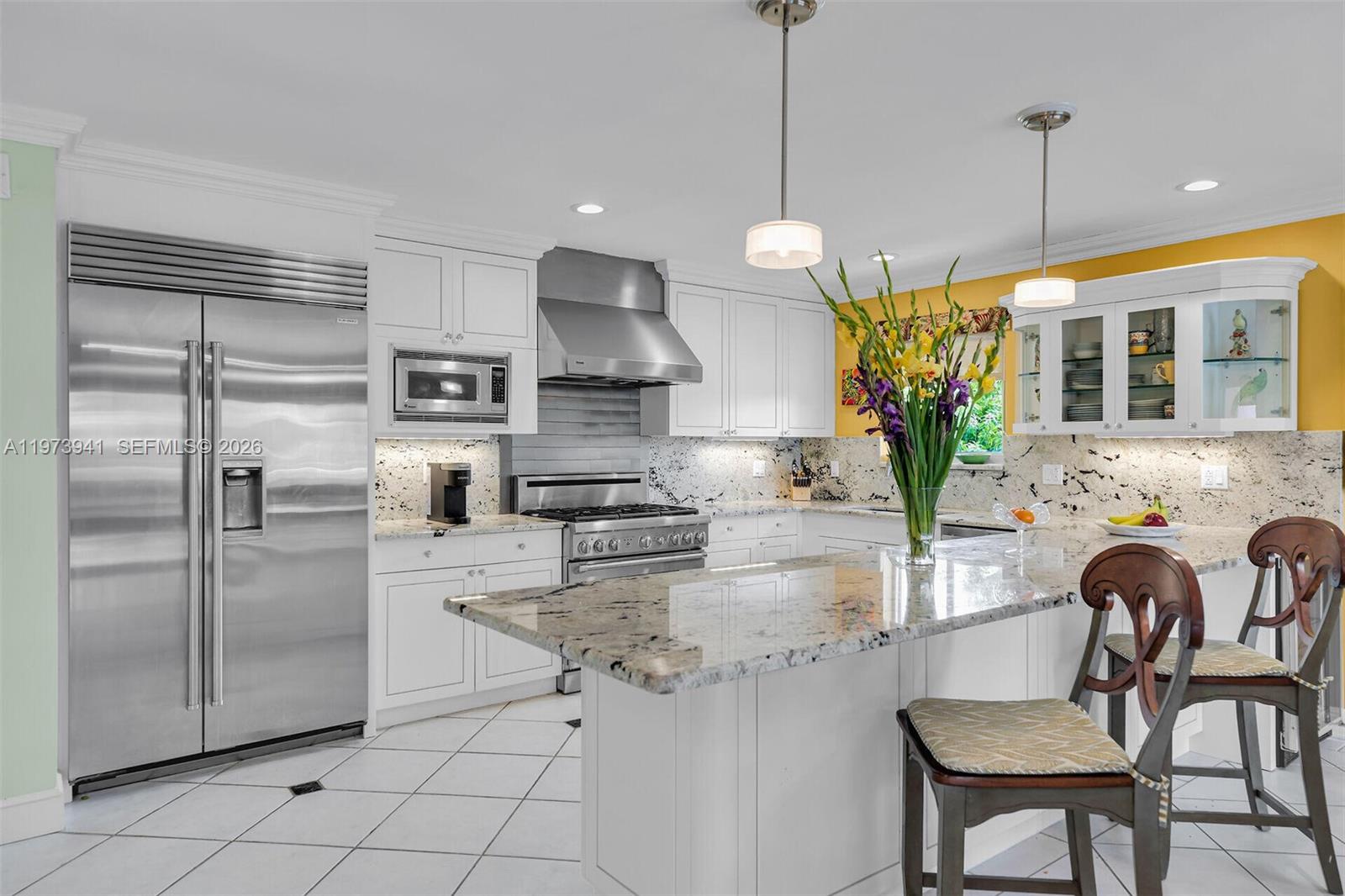A kitchen features white cabinets, granite countertops, stainless steel appliances, and a central island — 1218 Mockingbird Rd, Key Largo FL 33037, KEY LARGO, FL