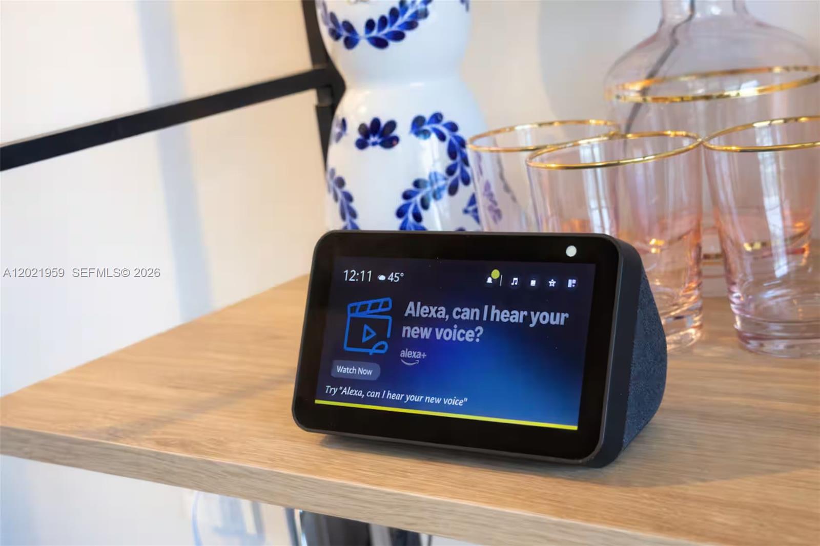 An Amazon Echo Show device sits on a wooden shelf next to decorative glassware — 1600 NE 1st Ave # 1605, Miami FL 33132, MIAMI, FL