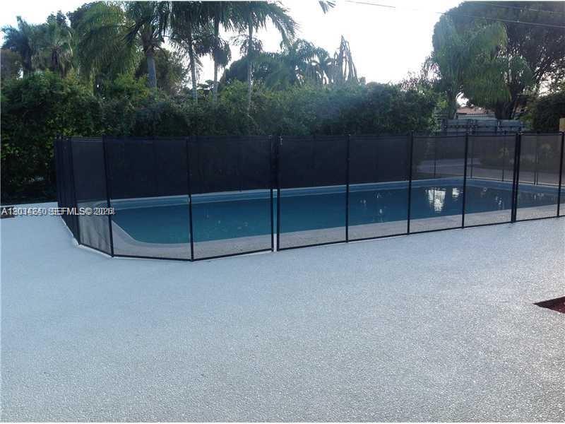 A kitchen features dark wood cabinets, stainless steel appliances, and a stone tile backsplash — 1324 Washington St, Hollywood FL 33019, HOLLYWOOD, FL