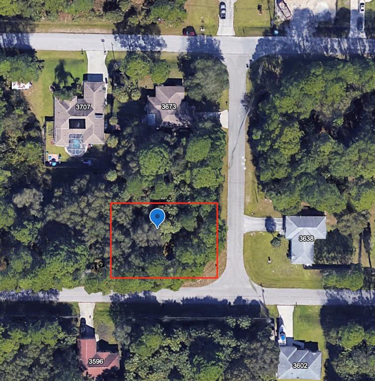An aerial view shows a vacant, wooded residential lot outlined in red between existing houses — Lot 13 GIBLIN DRIVE, NORTH PORT, FL