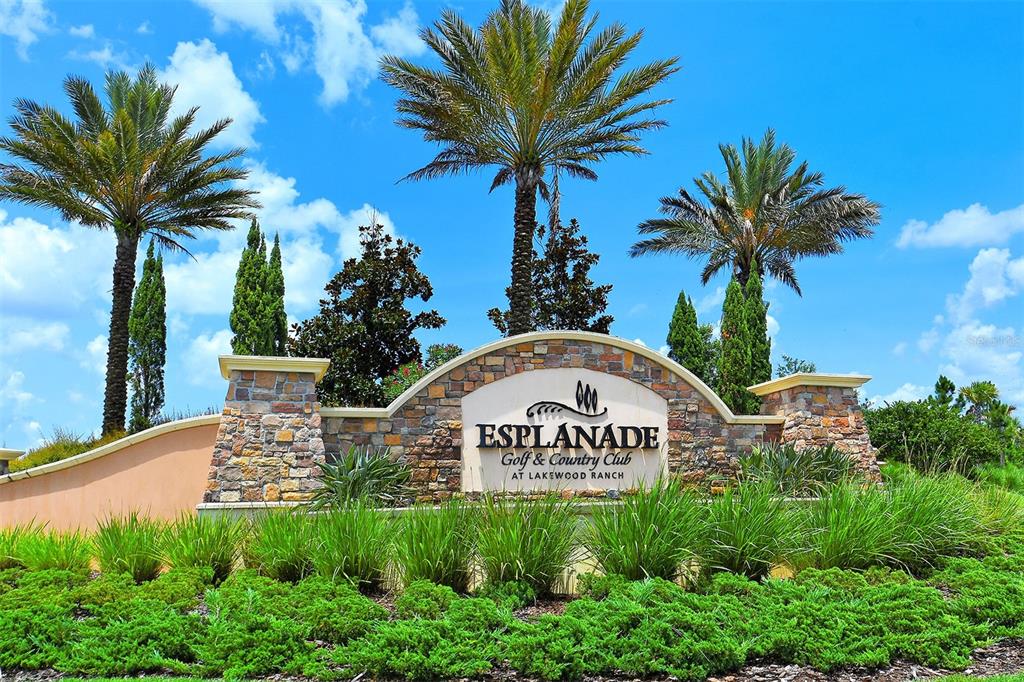 A stone monument sign for Esplanade Golf and Country Club stands amidst palm trees — 5137 NAPOLI RUN, BRADENTON, FL